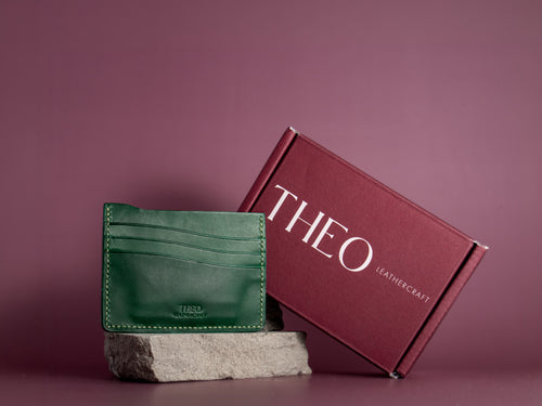 Green leather cardholder with 'THEO Leathercraft' packaging box