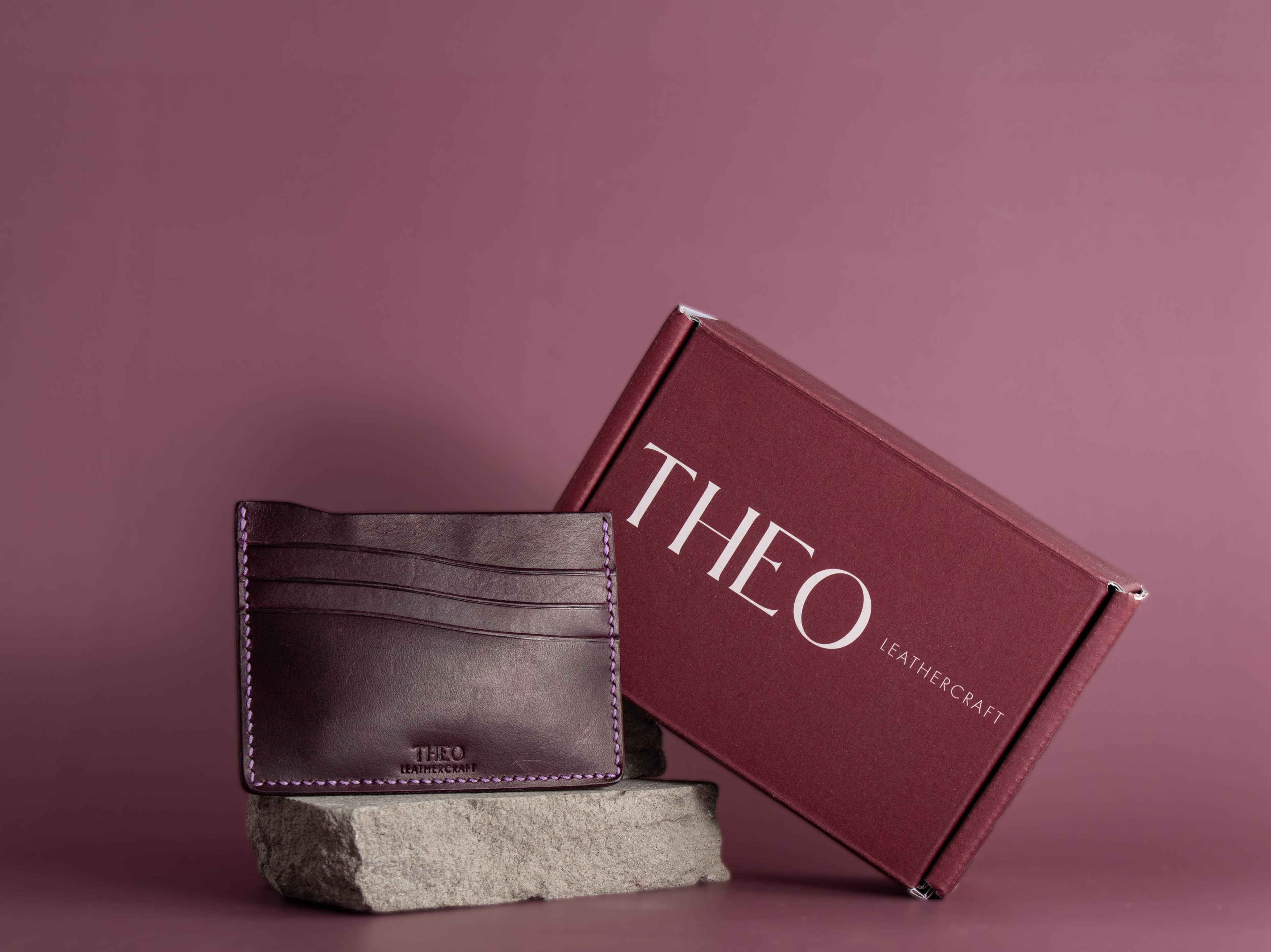 Brown leather wallet and 'THEO Leathercraft' with packaging
